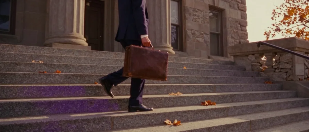A young attorney climbing the courthouse steps with a briefcase, period 1991 styling.