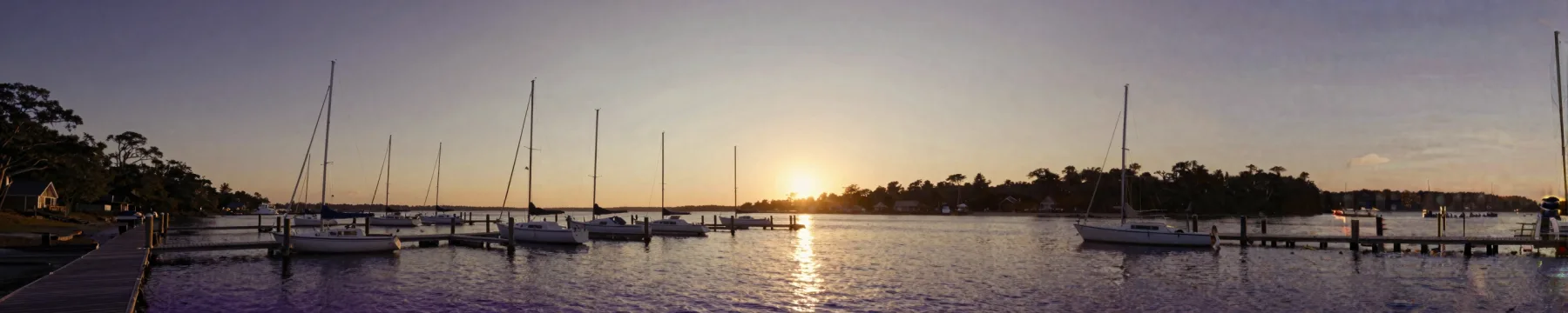 Boats at a marina in golden-hour light.