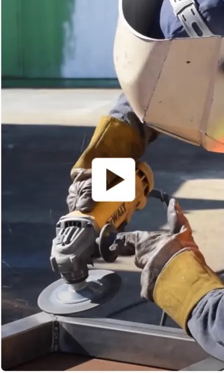 A fabricator grinding a container weld, from the video embedded on the live homepage.
